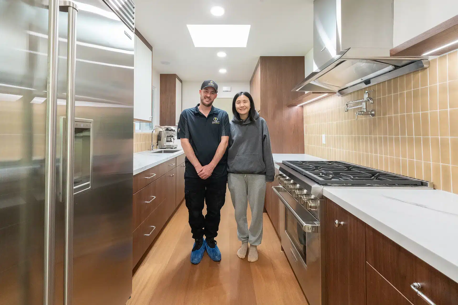 A Nailed It Builders team member with a homeowner in their completed kitchen remodel